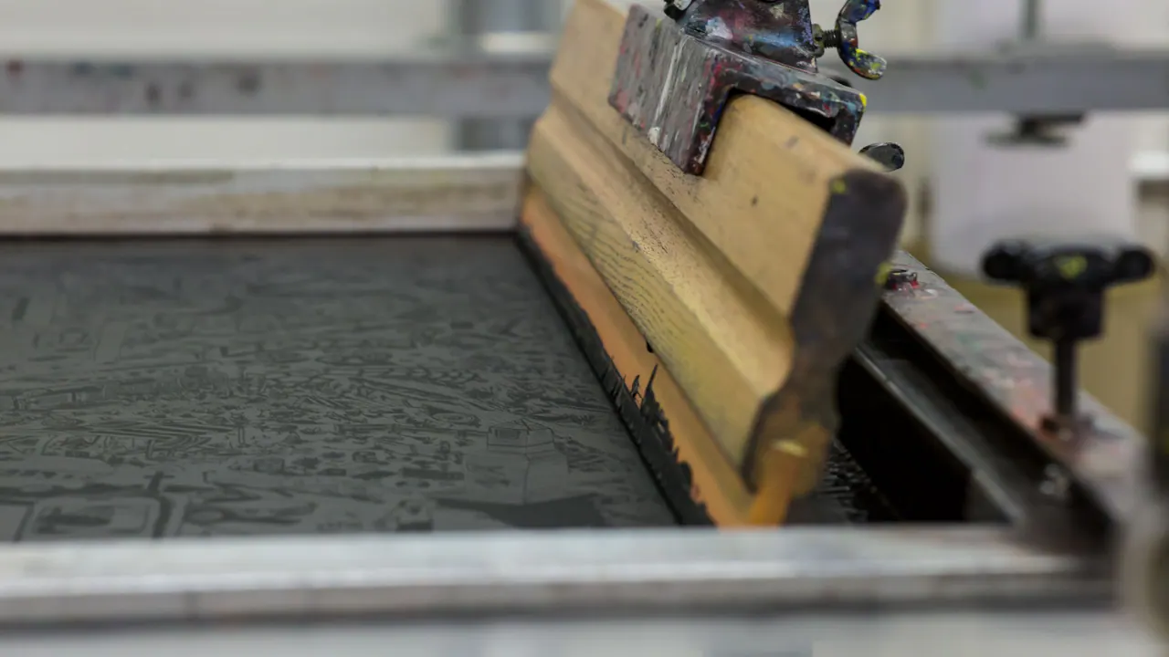 Ink being pulled across a screen with a squeegee