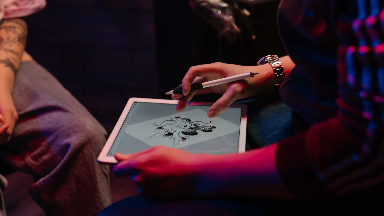 Designer preparing a logo on a laptop